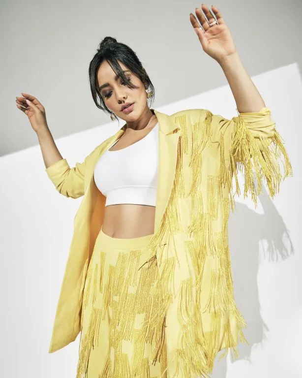 Neha Sharma in in Nirmooha's Lemon Yellow Cording Bralet with Ring and attached Hand Embroidered Tassels Fringes,Lemon Yellow Oversized Blazer with Hand embroidered Tassels Fringes and Pants from Magical Wilderness Collection